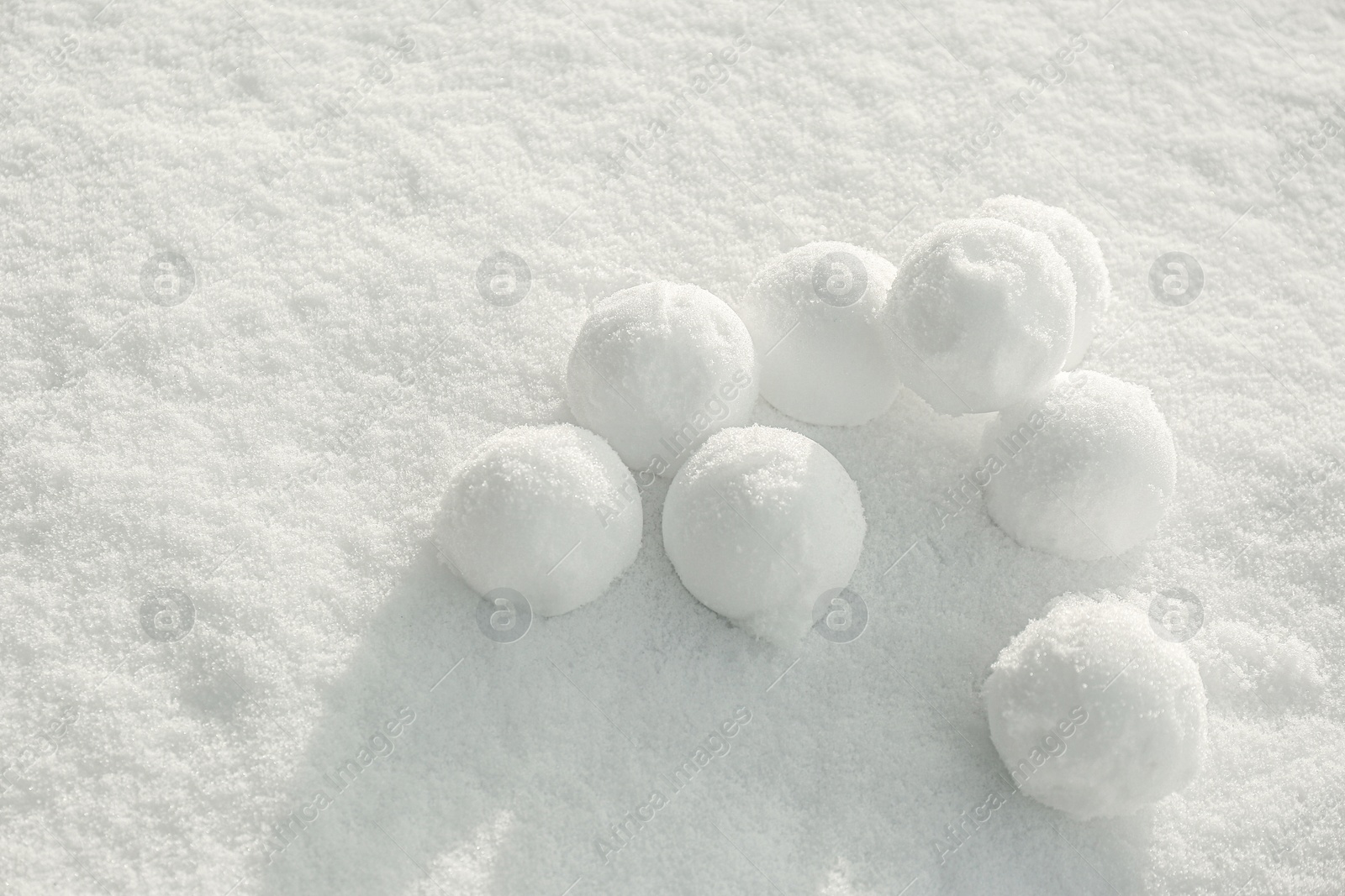 Photo of Pile of perfect round snowballs on snow outdoors