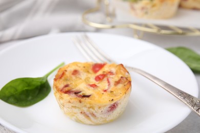 Photo of Freshly baked bacon and egg muffin with cheese served on table, closeup