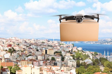 Image of Modern drone with carton box flying above city on sunny day. Delivery service 