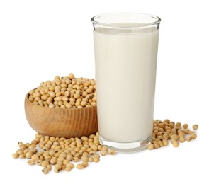 Photo of Glass of fresh soy milk and bowl with beans on white background