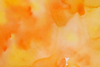 Photo of Abstract yellow and orange watercolor painting as background, top view