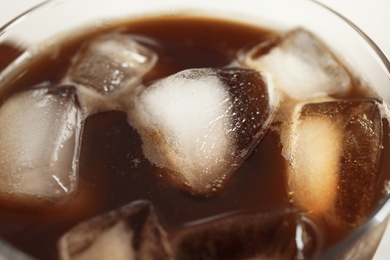 Photo of Coffee drink with ice cubes in glass, closeup