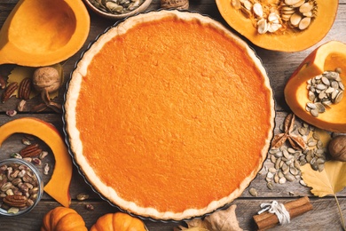 Flat lay composition with delicious homemade pumpkin pie on wooden table