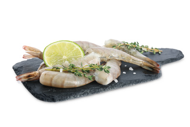 Photo of Slate plate with raw shrimps, lime and thyme isolated on white