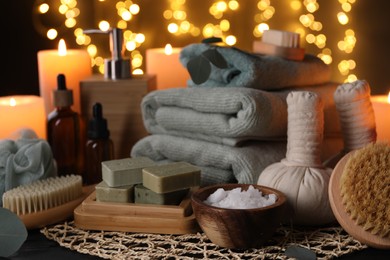 Photo of Beautiful composition with different spa products on table against blurred lights