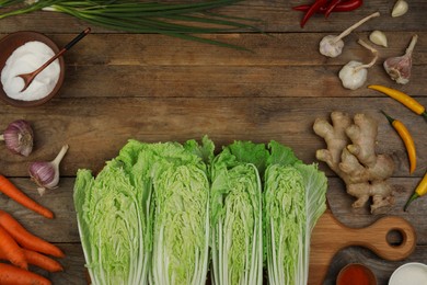 Photo of Flat lay composition with fresh Chinese cabbages and ingredients on wooden table