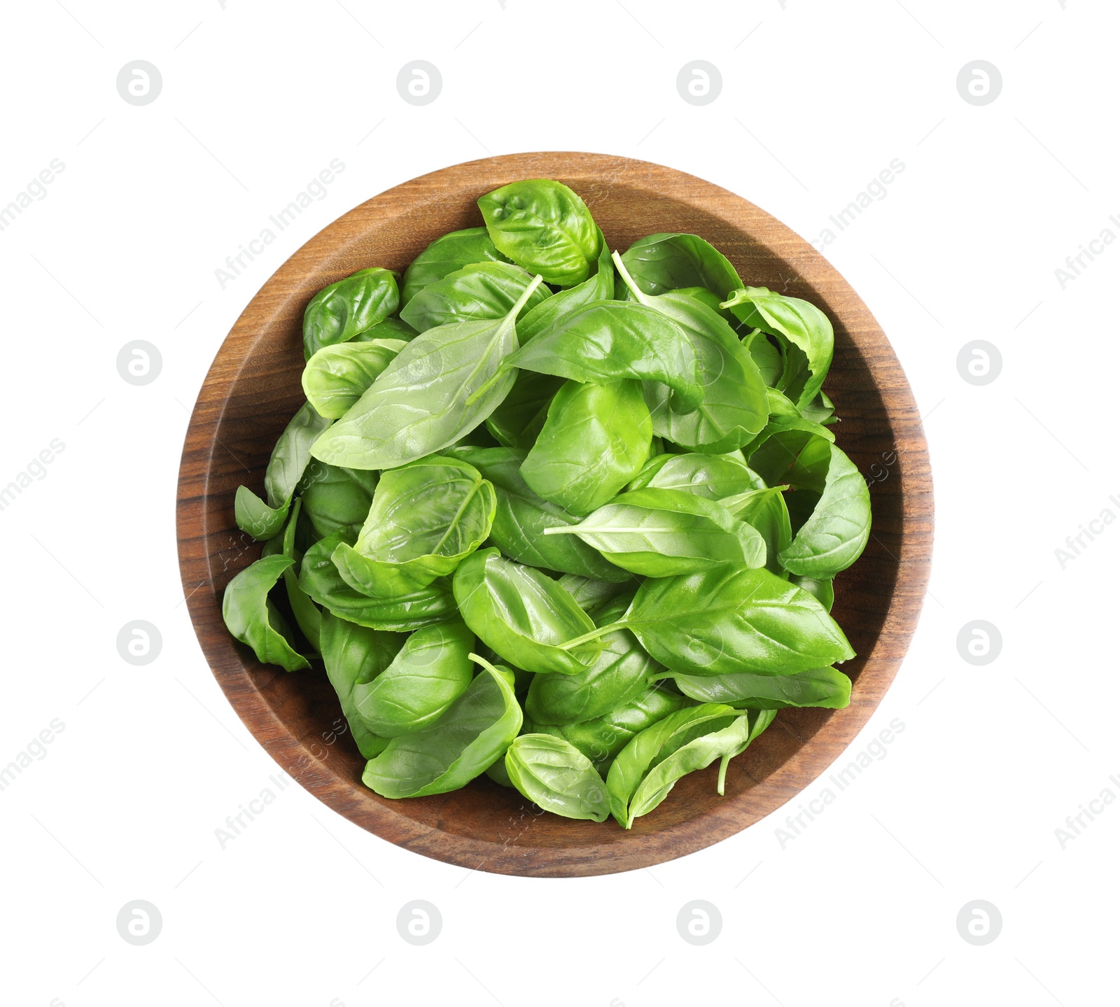 Photo of Fresh basil leaves in wooden bowl isolated on white, top view
