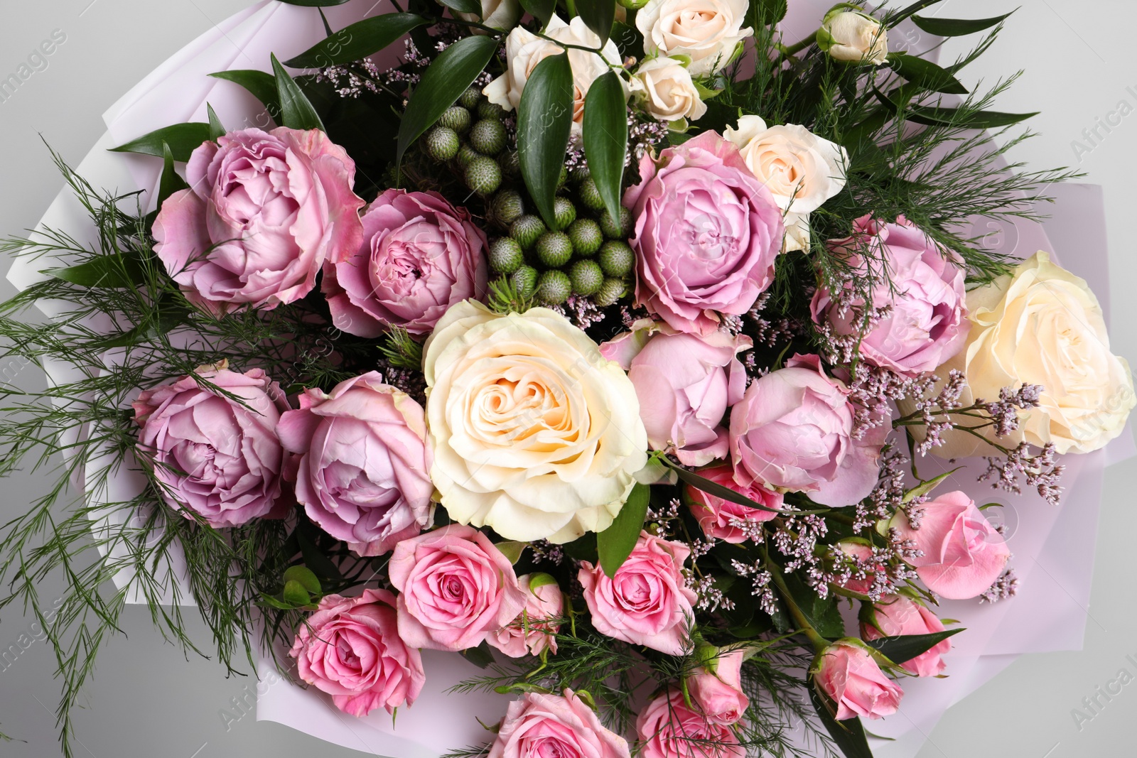 Photo of Beautiful bouquet with roses and leaves, closeup