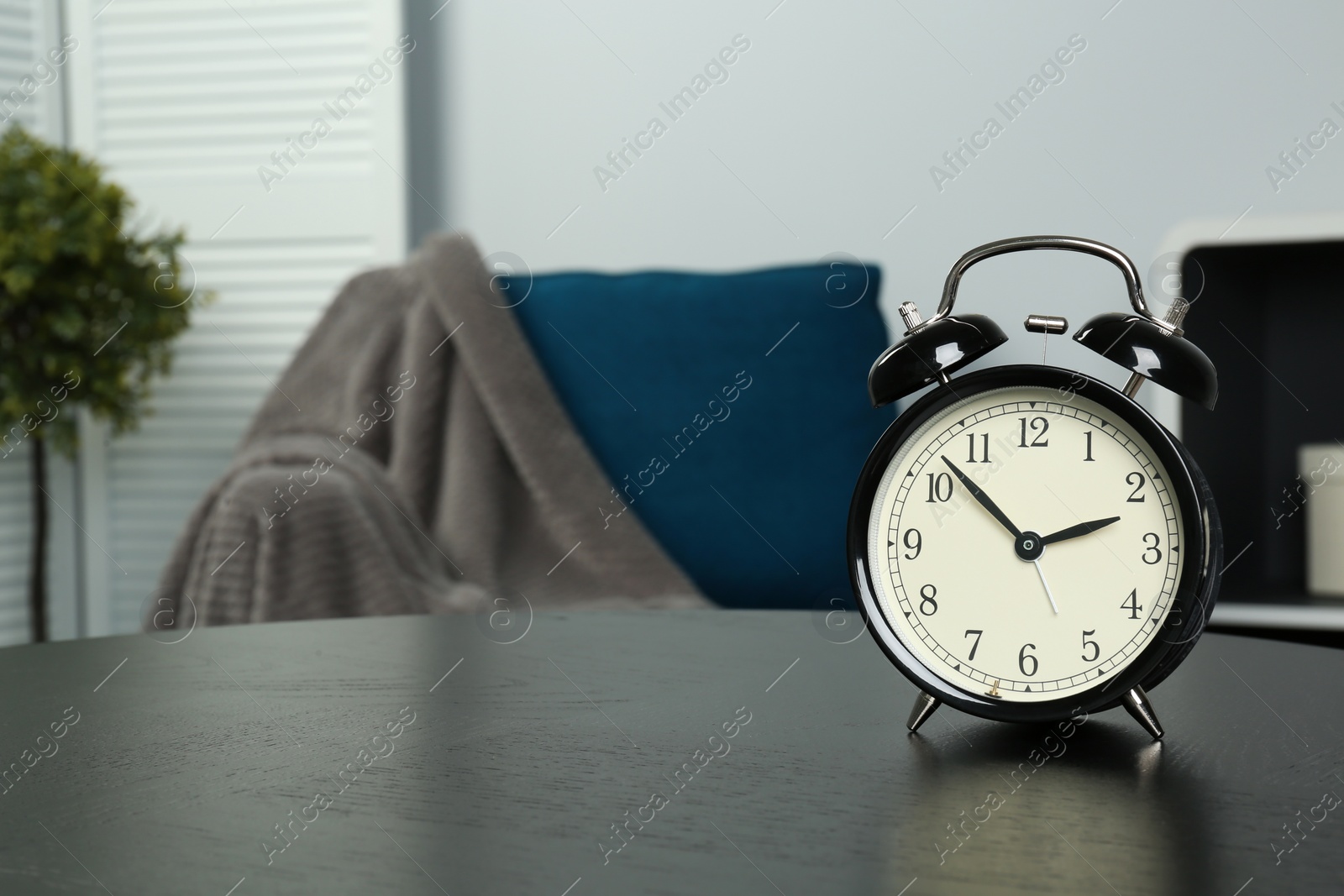 Photo of Alarm clock on table indoors, space for text. Time management