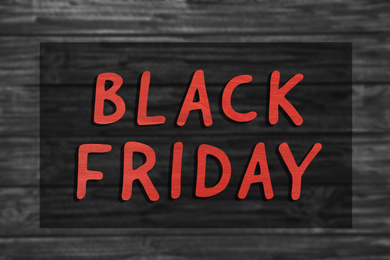 Phrase Black Friday and blurred view of wooden surface on background 