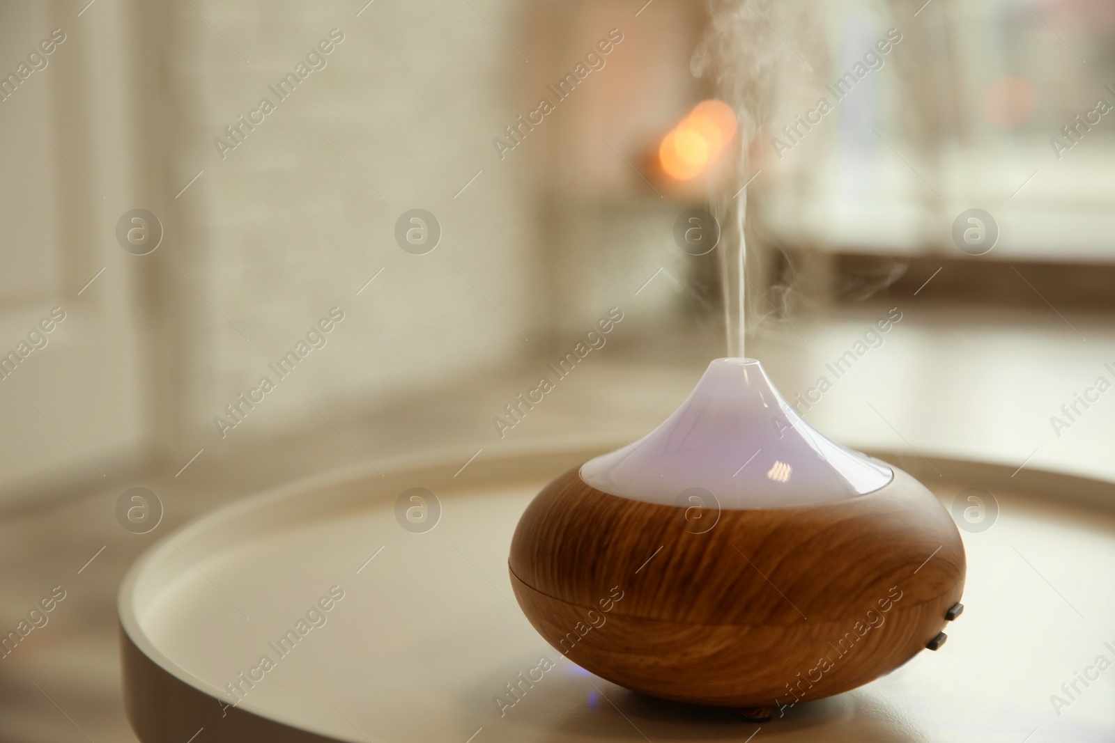 Photo of Aroma oil diffuser on table indoors