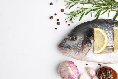 Photo of Flat lay composition with fresh raw dorado fish and ingredients on white table, space for text