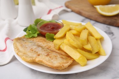 Photo of Delicious fish and chips with ketchup and lettuce on light table, closeup