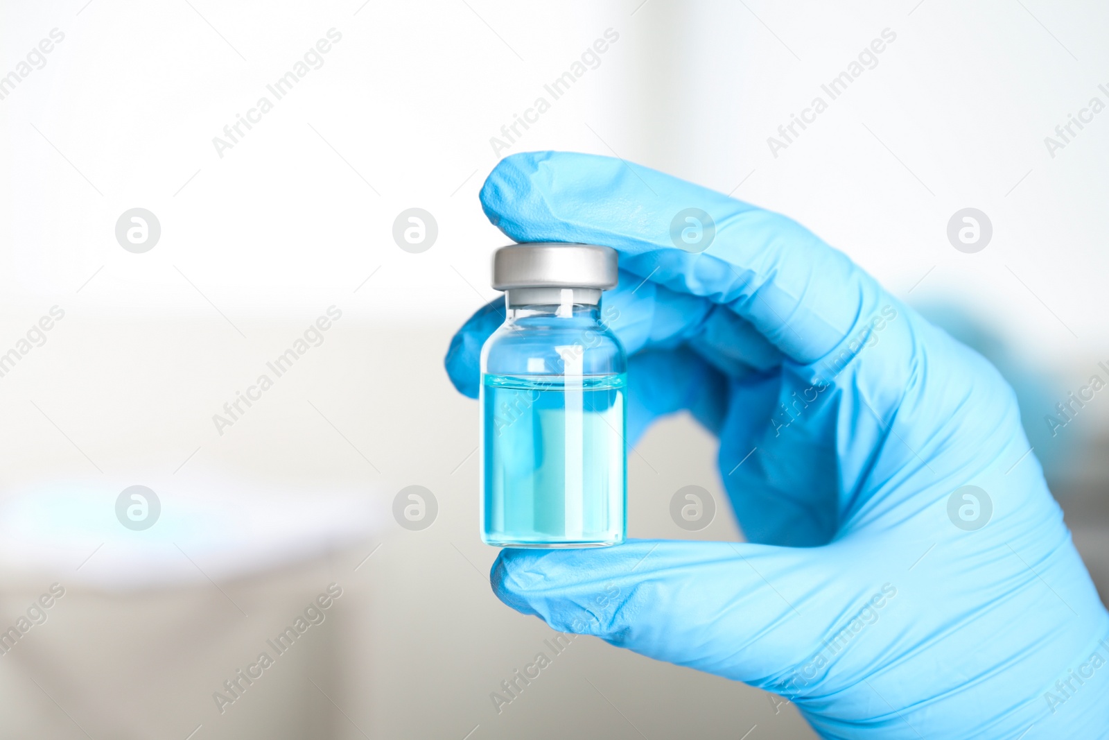 Photo of Doctor holding vial with medication, closeup. Vaccination and immunization