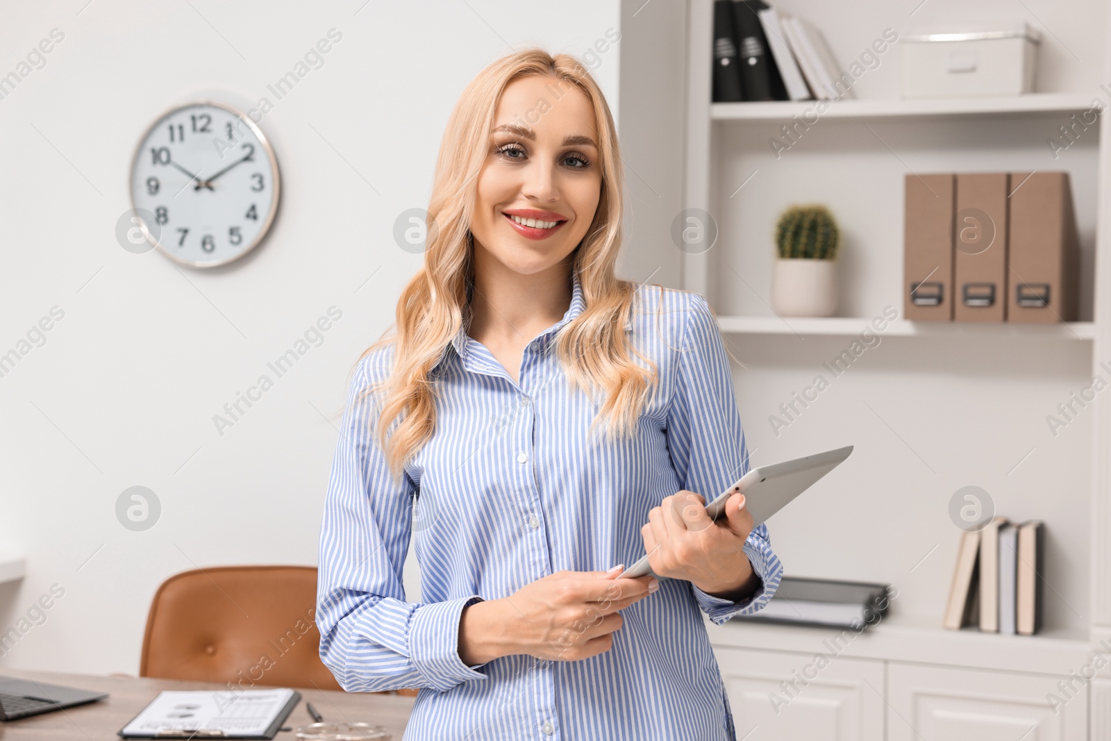 Photo of Portrait of happy secretary with tablet in office