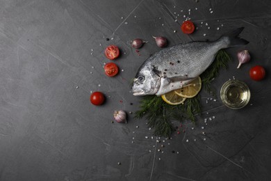 Photo of Fresh dorado fish and ingredients on grey table, flat lay. Space for text