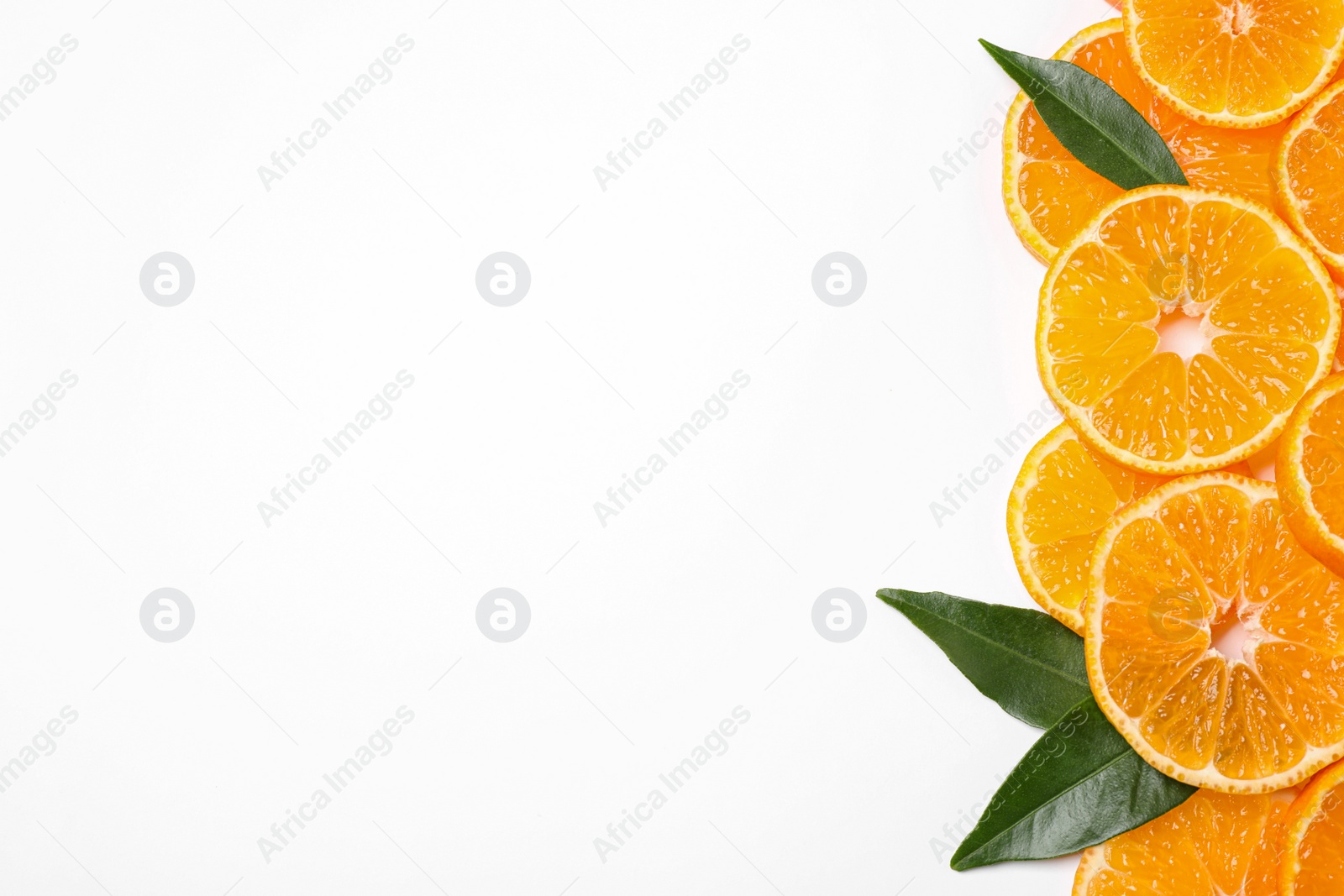 Photo of Composition with slices of fresh ripe tangerines and leaves on white background, top view. Citrus fruit