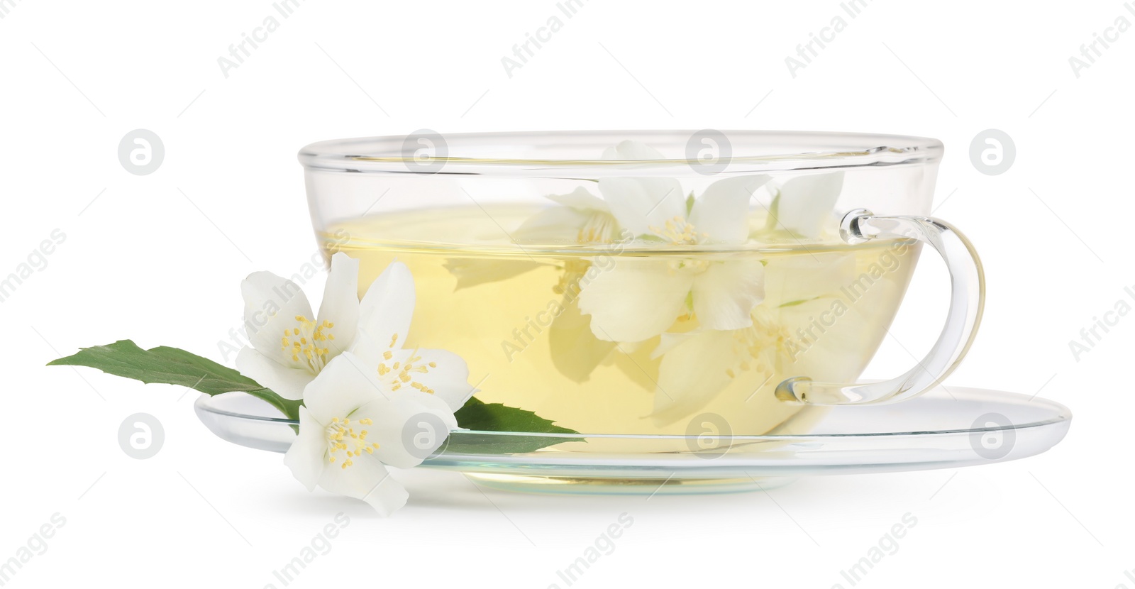 Photo of Aromatic herbal tea in glass cup, teapot and flowers isolated on white