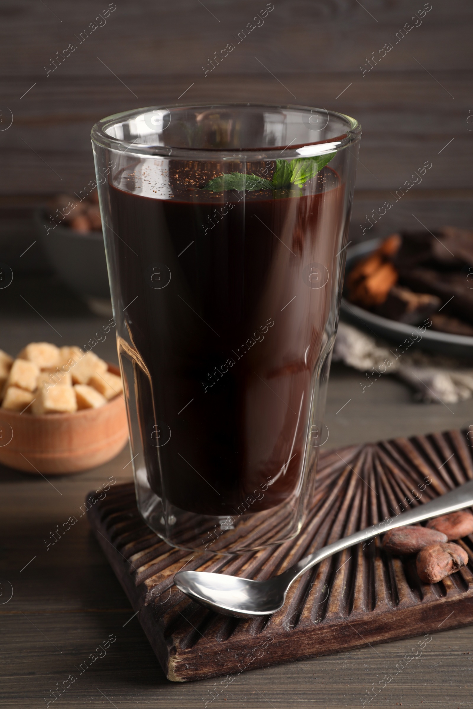 Photo of Glass of delicious hot chocolate with fresh mint on wooden table