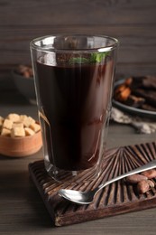 Photo of Glass of delicious hot chocolate with fresh mint on wooden table