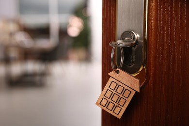 Closeup view of door with key open into room. Space for text