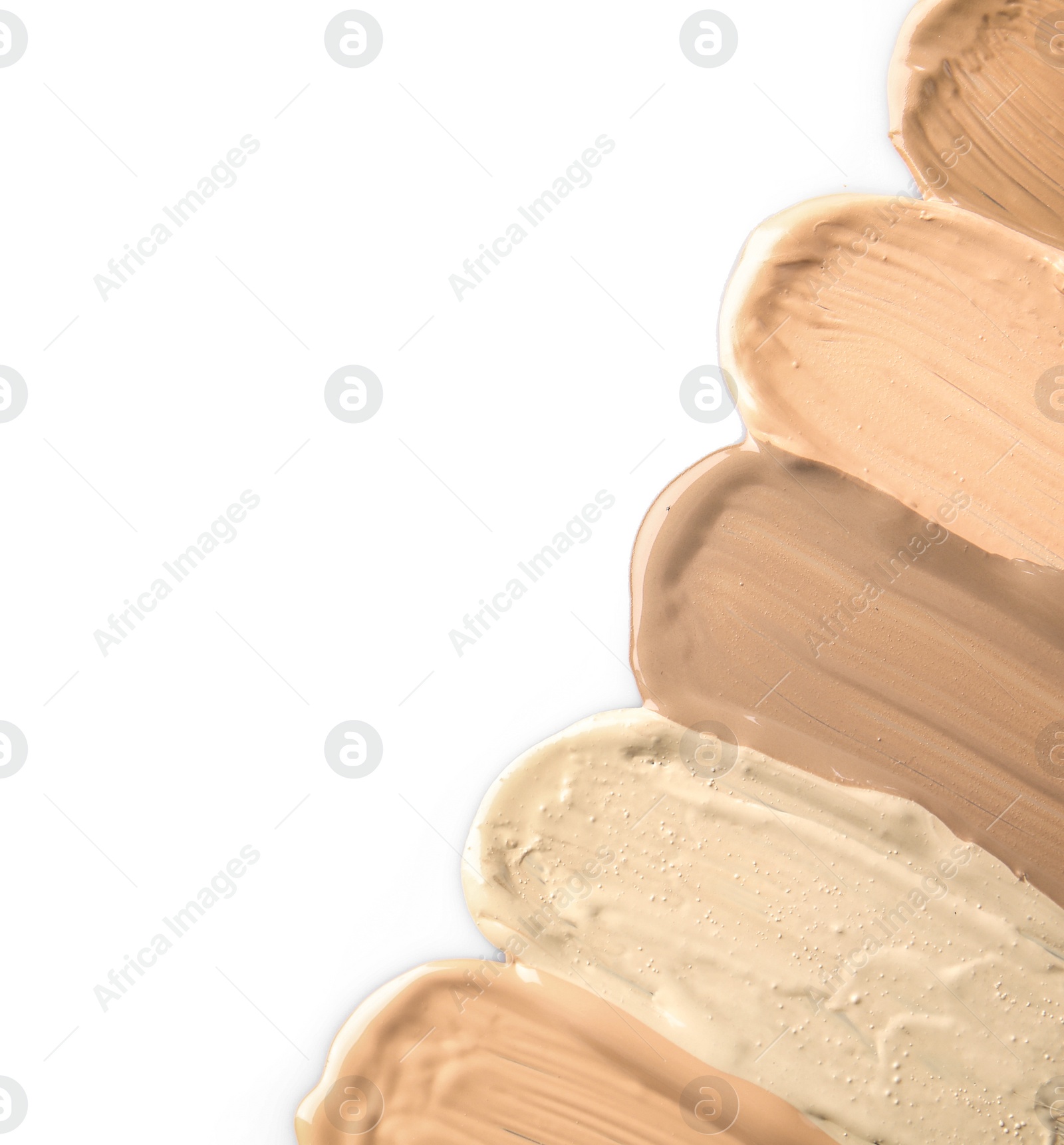 Photo of Samples of different foundation shades on white background, top view