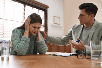 Professional psychotherapist working with patient in office