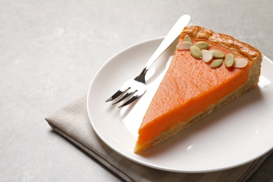 Photo of Plate with piece of fresh delicious homemade pumpkin pie on light table