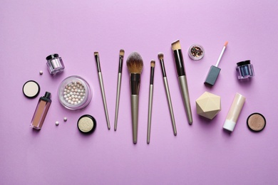 Photo of Flat lay composition with makeup brushes on lilac background