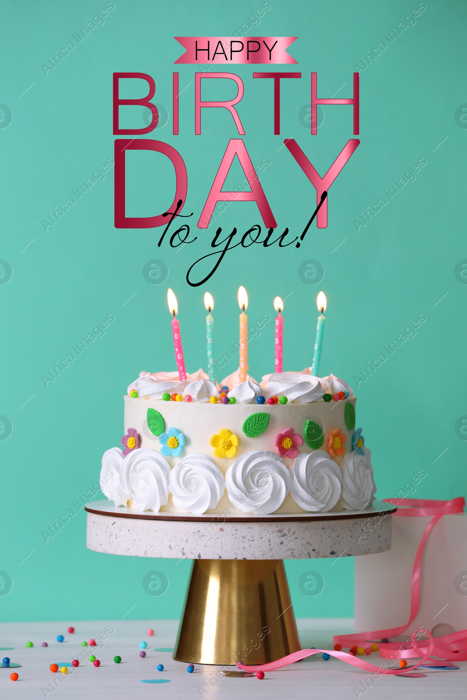 Image of Happy Birthday! Delicious cake and party decor on white wooden table against turquoise background