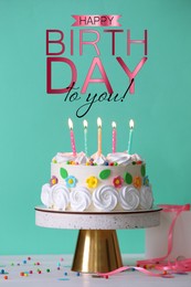 Happy Birthday! Delicious cake and party decor on white wooden table against turquoise background