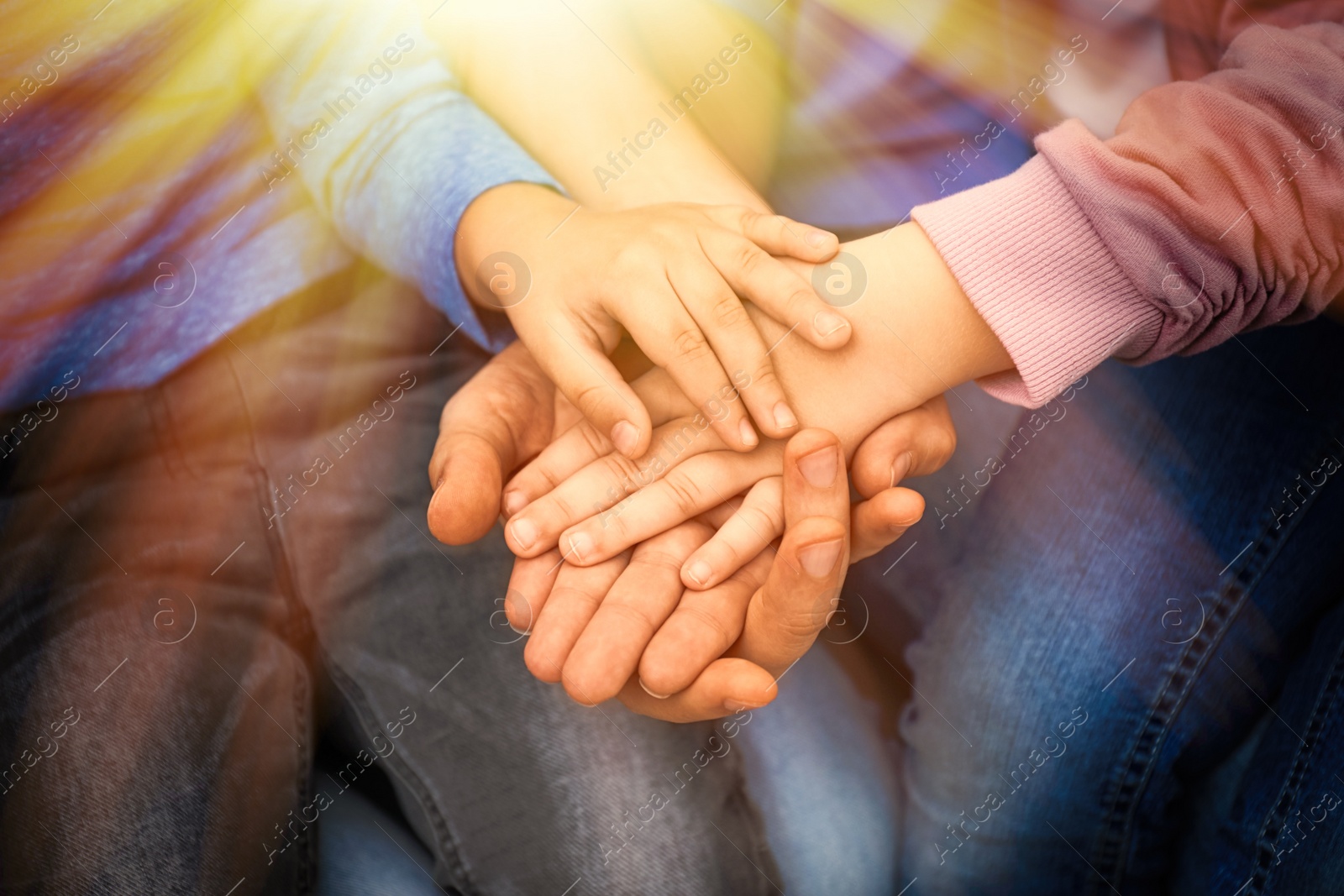 Image of Closeup view of happy family holding hands 