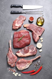 Fresh raw beef cuts, spices and butcher tools on light grey textured table, flat lay