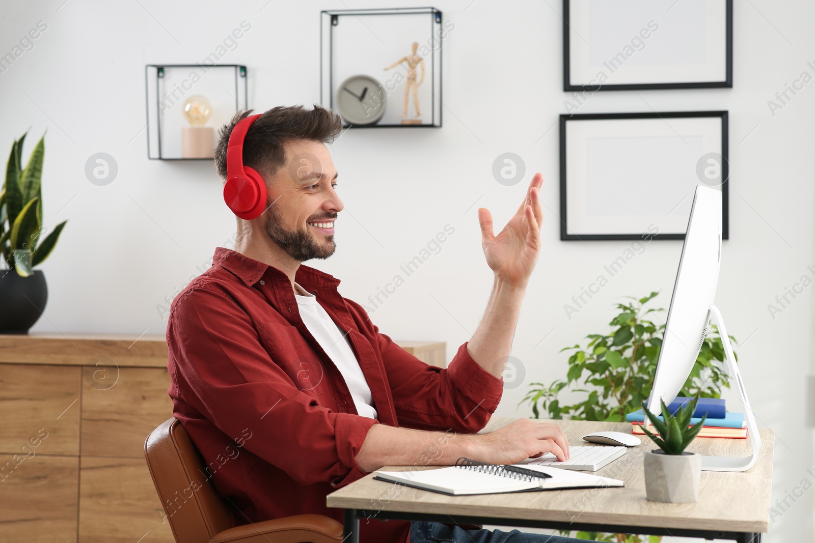 Photo of Man in headphones studying on computer at home. Online translation course