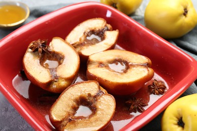 Photo of Tasty baked quinces with honey in dish on table, closeup
