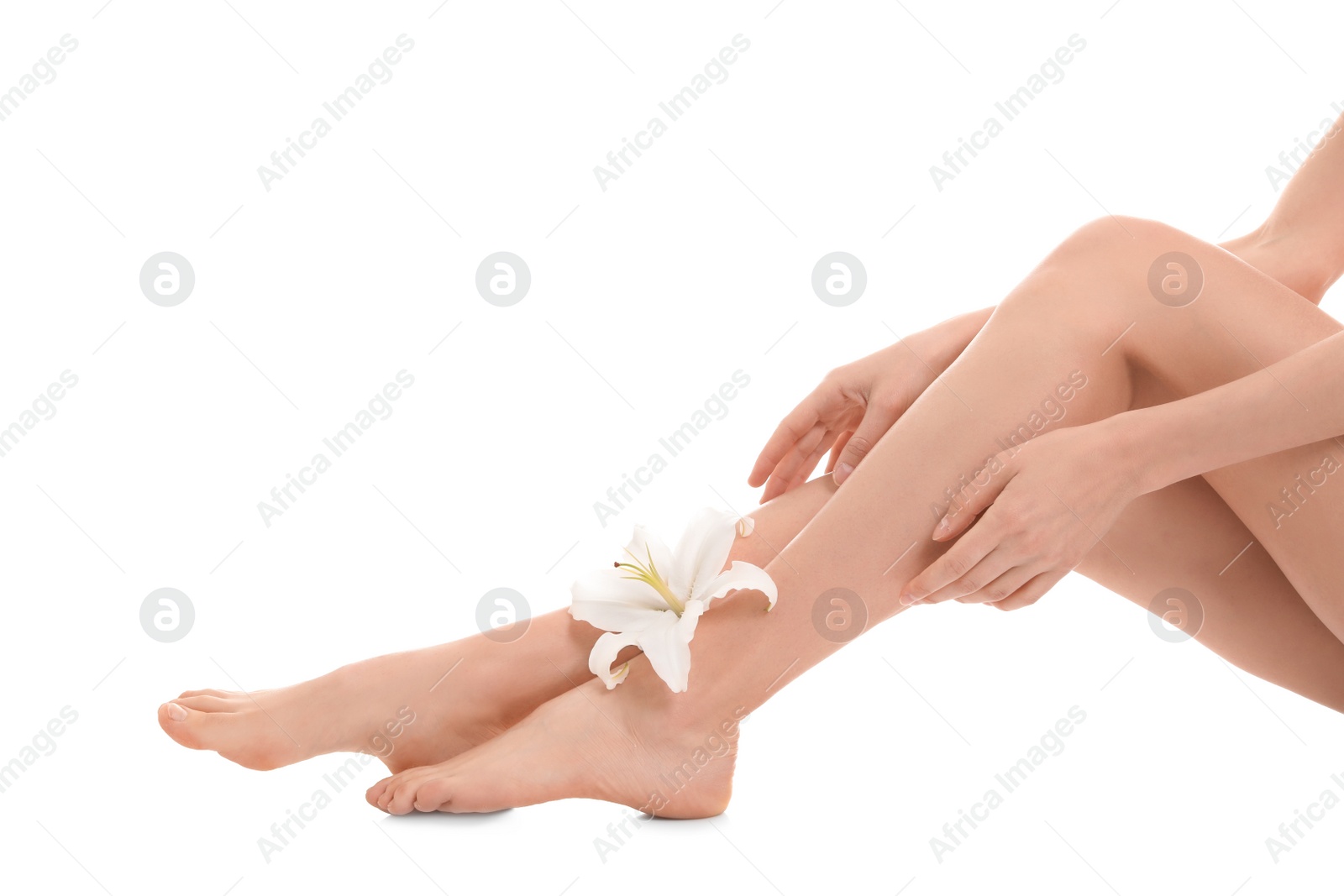 Photo of Young woman with flower showing smooth silky skin after epilation on white background