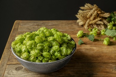 Fresh green hops and spikes on wooden table