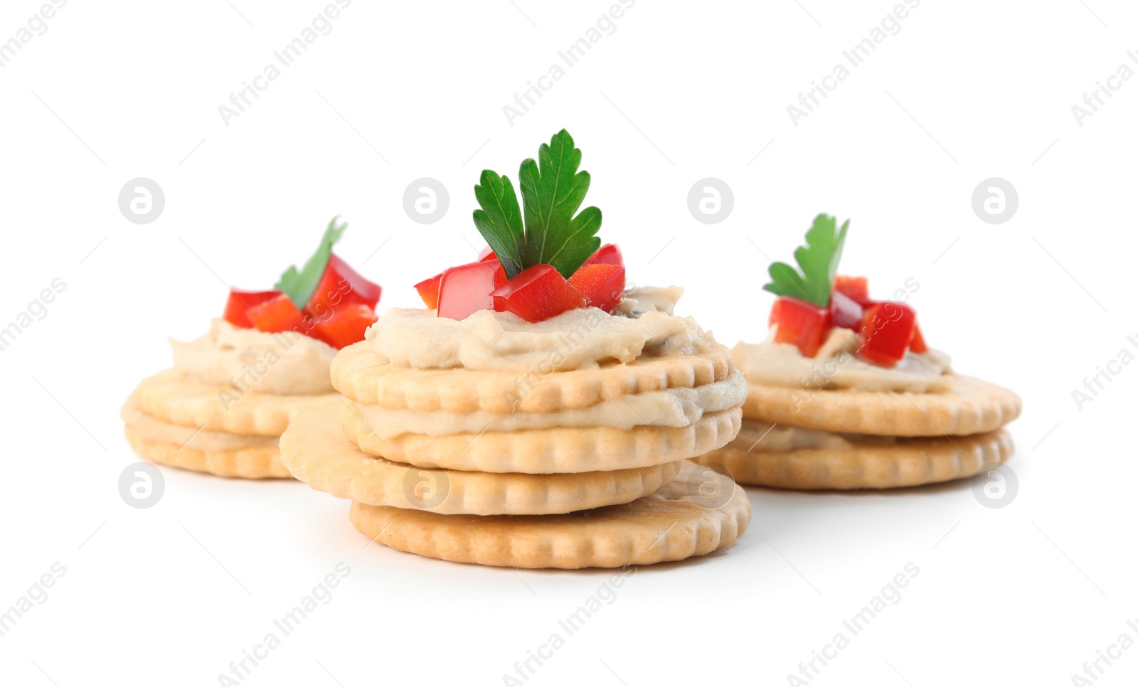 Photo of Delicious crackers with humus, bell pepper and parsley on white background