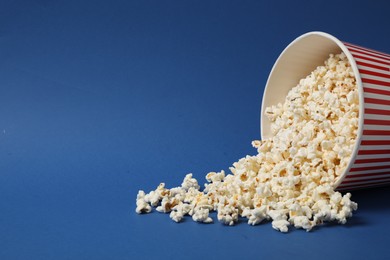 Delicious popcorn on blue background. Space for text