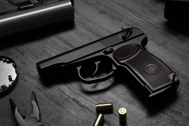 Photo of Standard handgun on dark table. Semi-automatic pistol