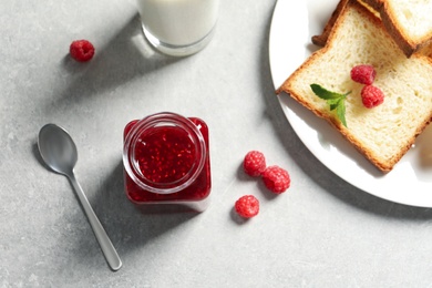 Image of Sweet raspberry jam and toasts for breakfast on table, flat lay
