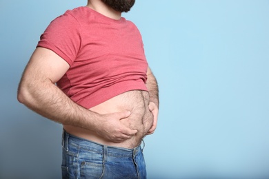 Photo of Overweight man on color background