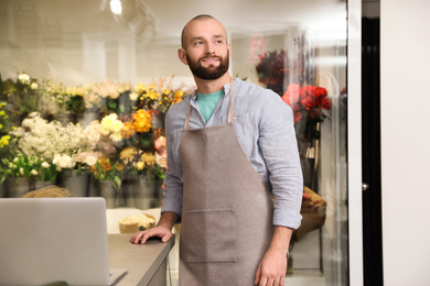 Photo of Professional male florist in apron at workplace