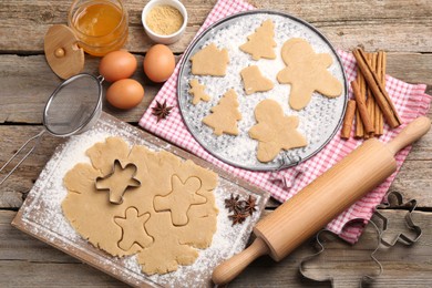 Photo of Making Christmas cookies. Flat lay composition with ingredients and raw dough on wooden table