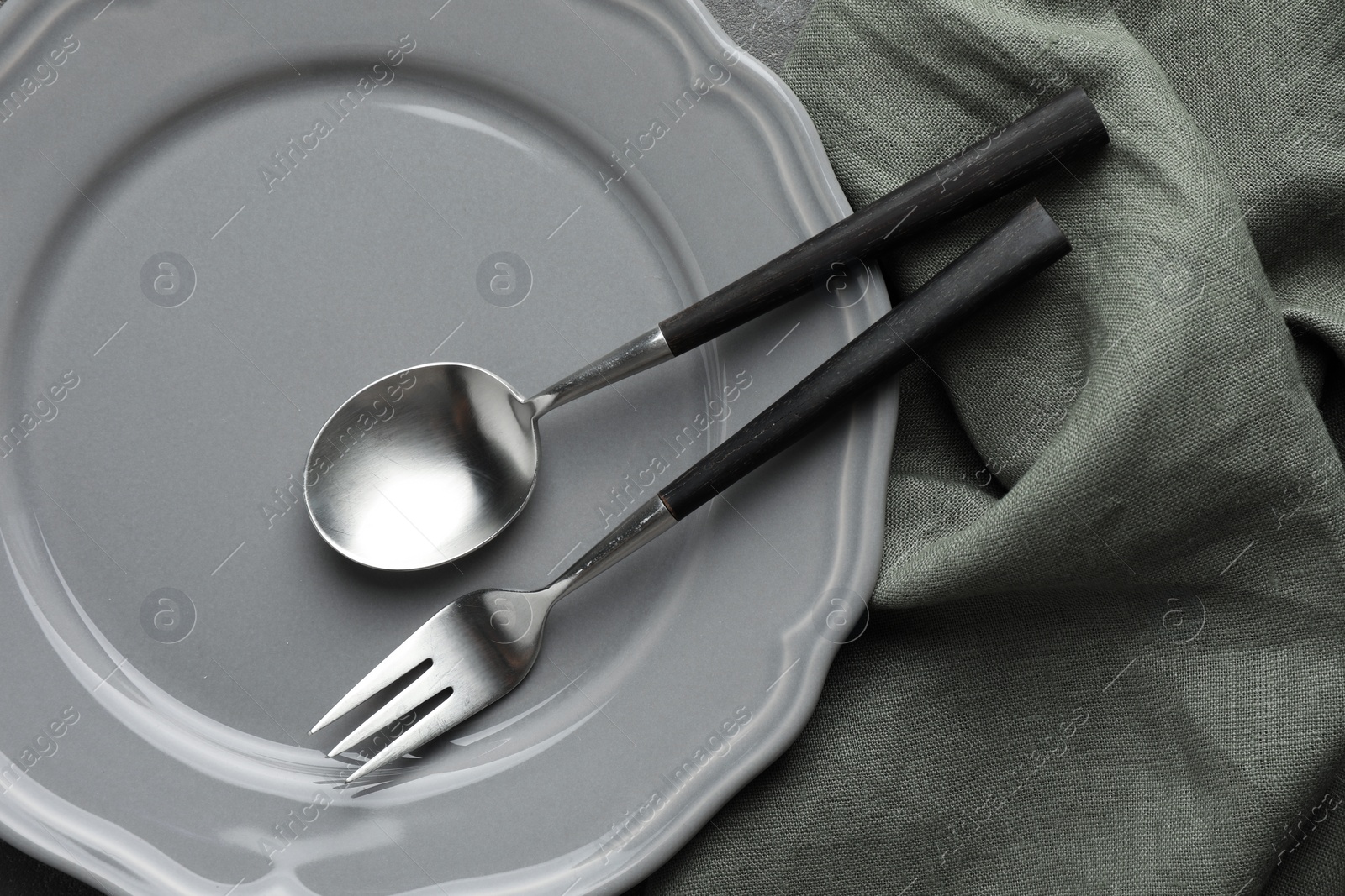 Photo of Stylish setting with cutlery and plate on table, top view