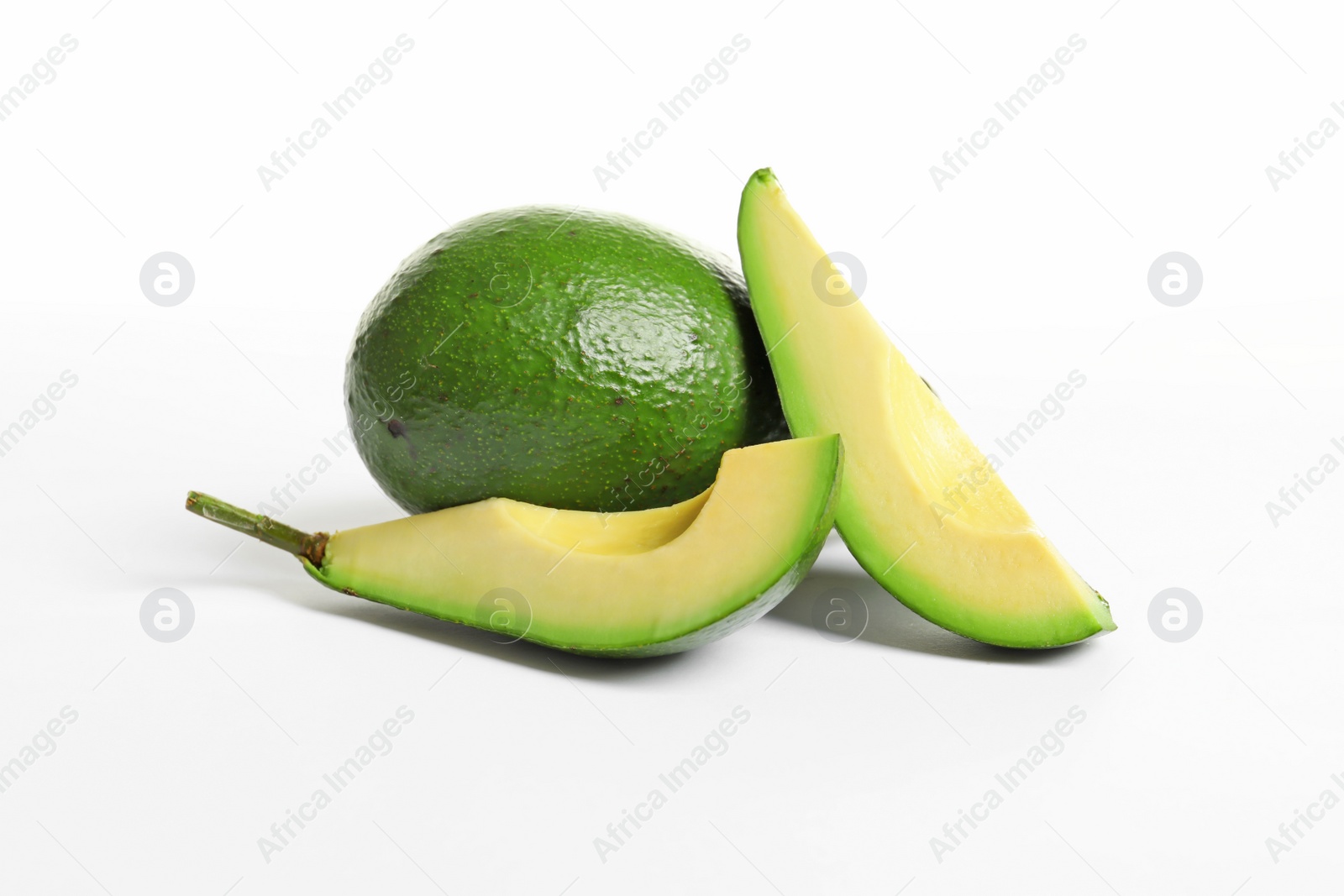 Photo of Ripe fresh avocados on white background