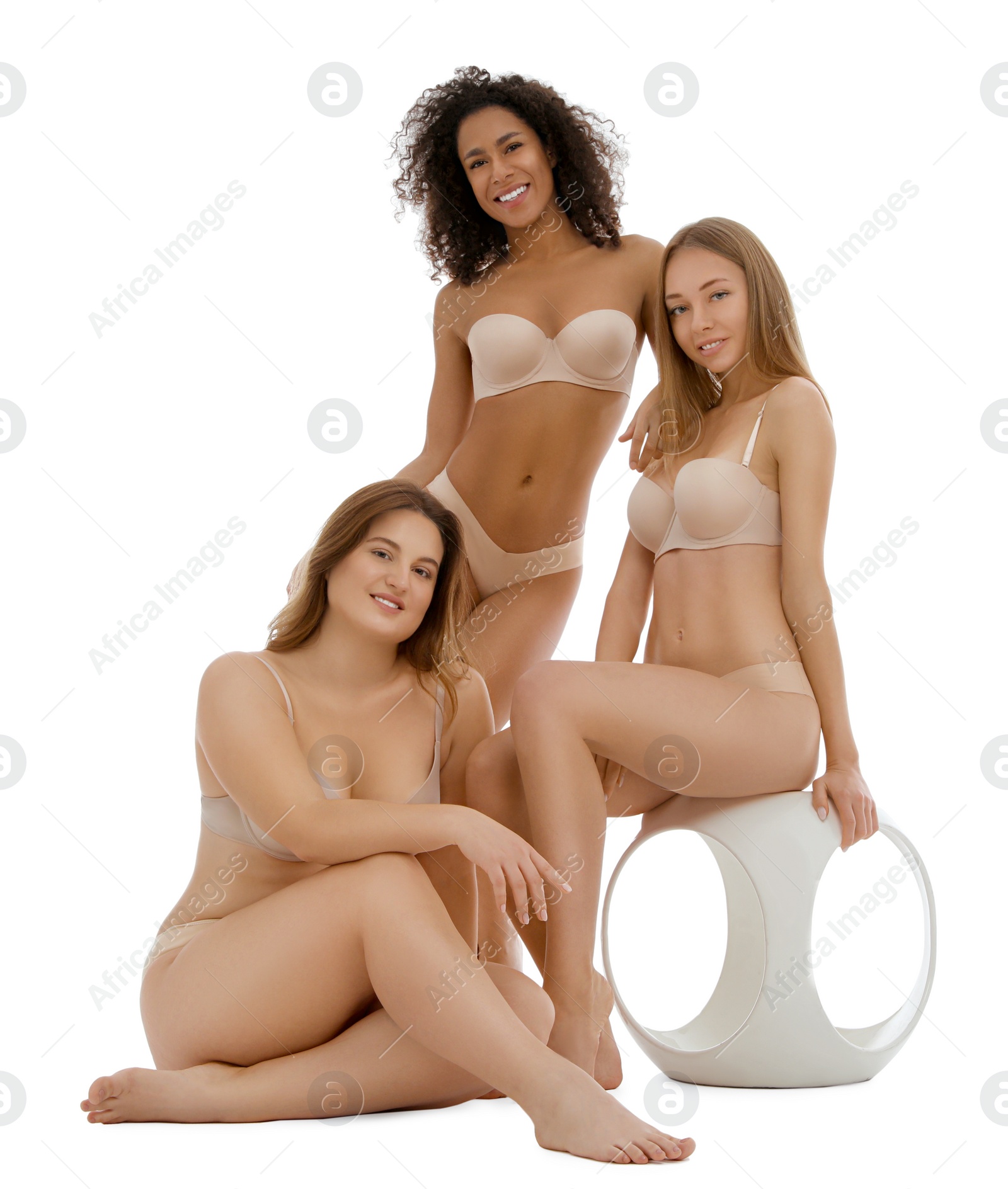 Photo of Group of women with different body types in underwear on white background