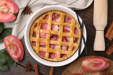 Photo of Flat lay composition with tasty apple pie, spices and fruits on wooden table