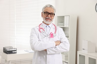 Mammologist with pink ribbon in hospital. Breast cancer awareness