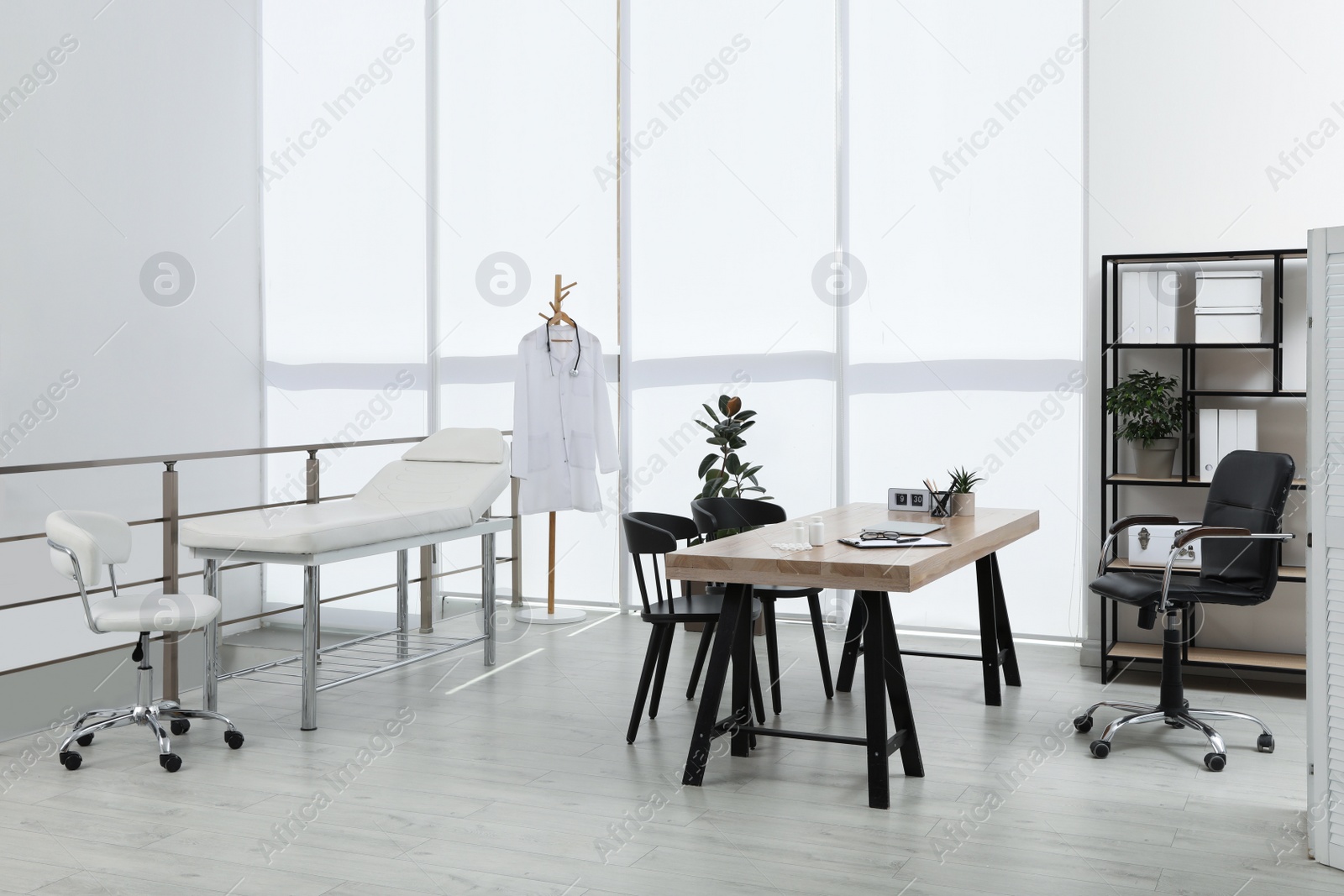 Photo of Modern medical office interior with doctor's workplace